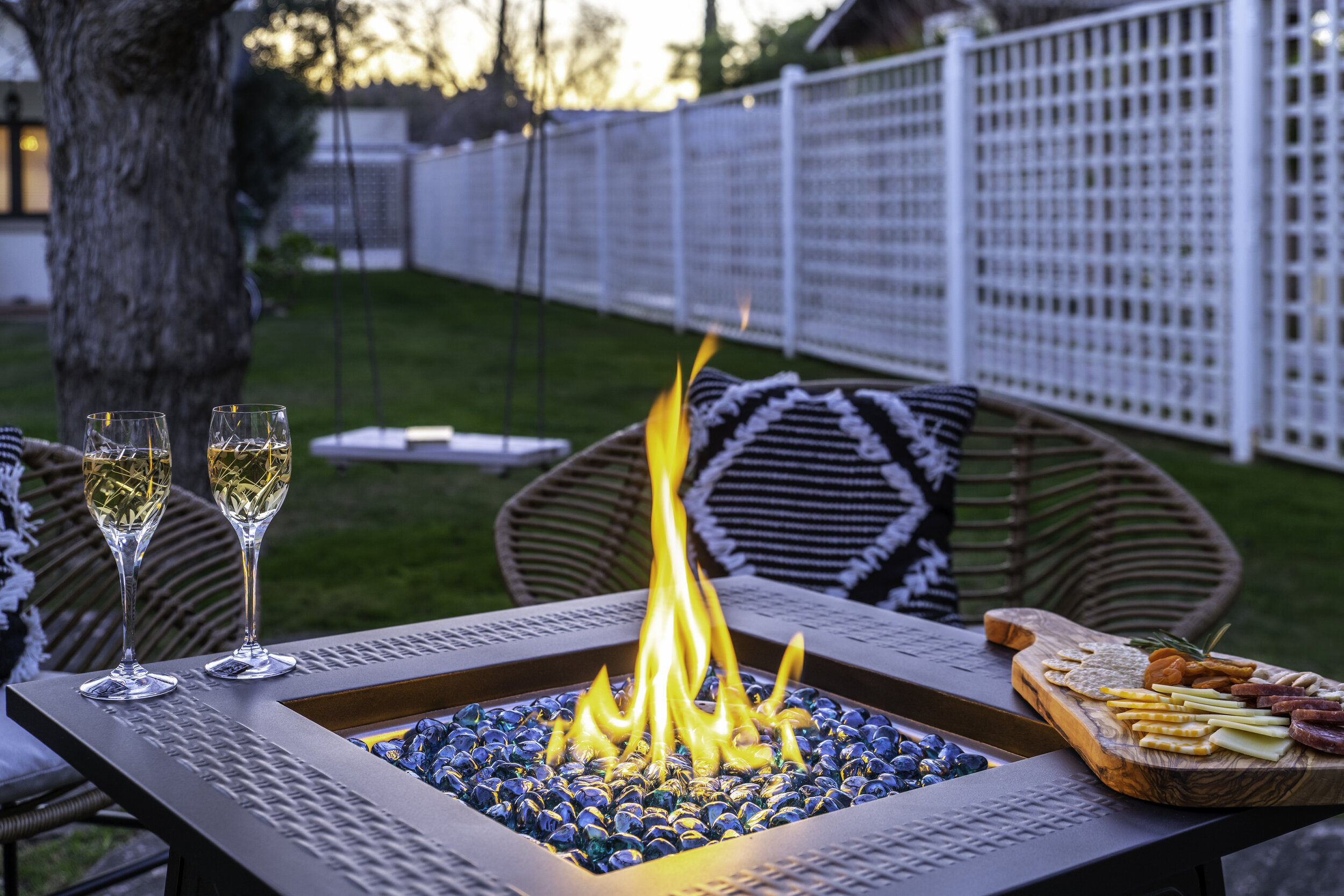 Backyard propane fire pit area with seating